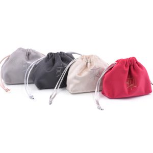 Luxury velvet drawstring jewelry pouch in customizable color, perfect for packaging rings, necklaces, earrings, and cosmetic gifts, with embroidered logo option.