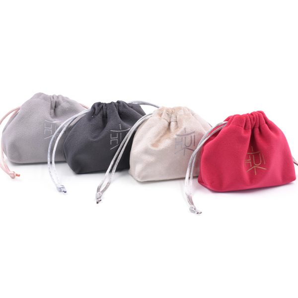 Luxury velvet drawstring jewelry pouch in customizable color, perfect for packaging rings, necklaces, earrings, and cosmetic gifts, with embroidered logo option.