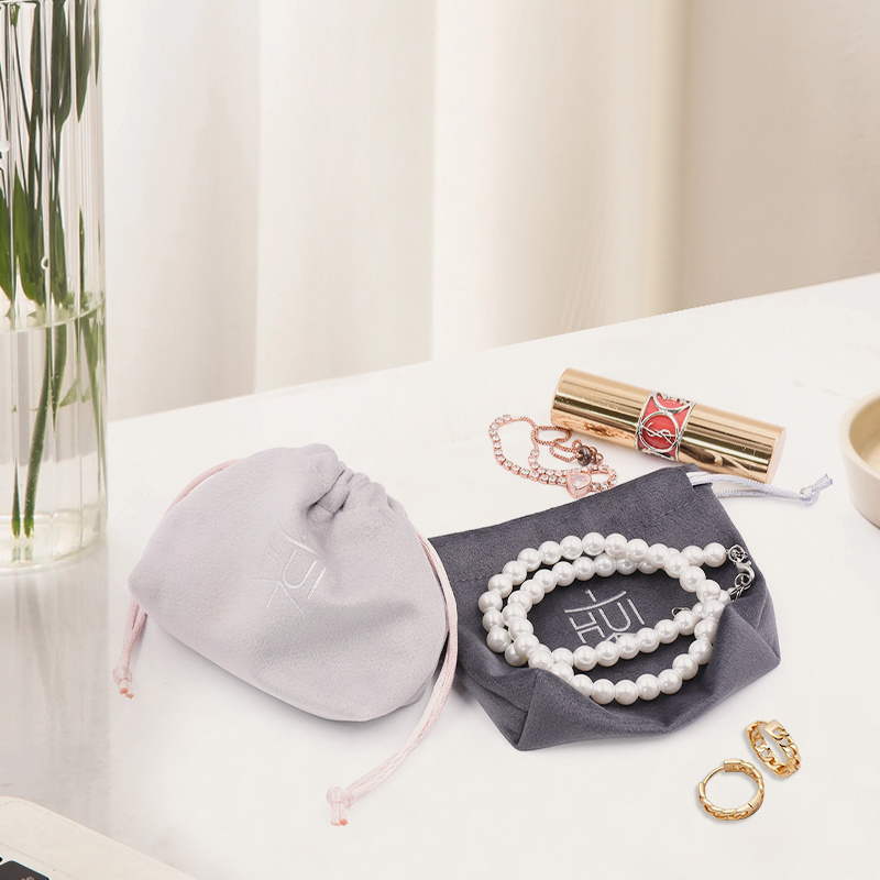 Luxury velvet drawstring jewelry pouch in customizable color, perfect for packaging rings, necklaces, earrings, and cosmetic gifts, with embroidered logo option.